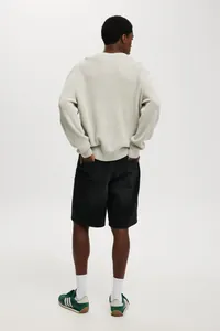 Back view of men's classic black denim shorts styled with socks and sneakers