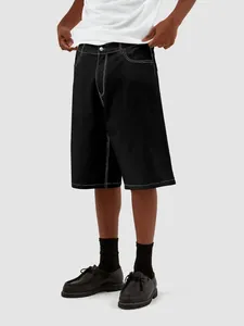 Loose fit men's black denim shorts featuring distinctive white contrast stitching