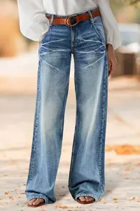 Full-length view of women's casual wide-leg denim jeans with faded wash and whisker detail