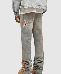 Back view of men's straight jeans featuring koi fish and floral embroidery patches