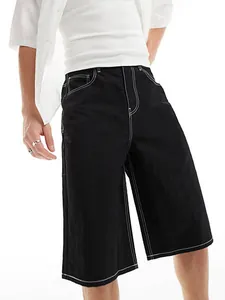 Detail of men's black denim shorts featuring distinctive white contrast stitching