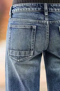 Detail shot showing the back pocket stitching on women's blue straight-leg denim jeans.