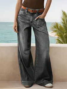 Front view of women's loose wide-leg jeans with large pockets and faded gray wash