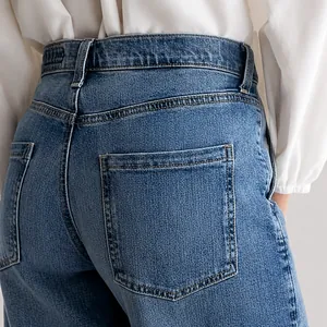 Detailed macro shot of back pockets on blue high-waisted wide-leg casual denim jeans