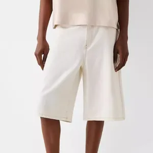 Stylish men's loose fit cream denim shorts featuring distinct contrast stitching details