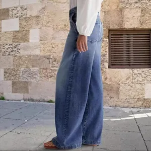 Women's high-waisted wide-leg denim jeans in washed blue, casual lifestyle fashion look