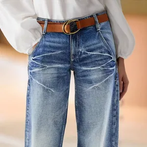 Stylish women's blue straight-leg denim jeans featuring unique distressed cat-whisker wash