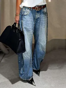 Detailed macro view of vintage washed denim wide-leg jeans with retro aesthetic styling