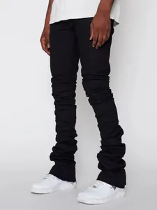 Men's black stacked denim jeans with ruched detailing and raw hem street style fashion