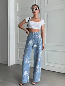 Full body view of high waist blue floral print jeans styled with a white crop top.