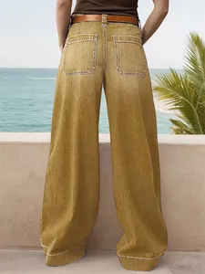 Rear view of high-waisted wide-leg denim trousers in mustard yellow with pocket detail
