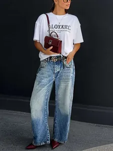 Model wearing vintage washed wide-leg denim jeans with a stylish retro street style vibe
