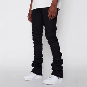 Men's stylish streetwear black stacked denim jeans with ruched leg and raw hem detail