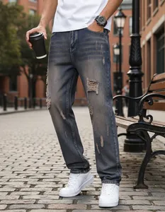 Detail view of men's distressed straight-leg denim jeans in an urban street setting