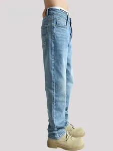 Detailed side view of men's light blue straight-leg jeans featuring a washed denim texture