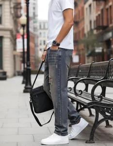 Urban lifestyle view of men's distressed straight-leg jeans with vintage wash
