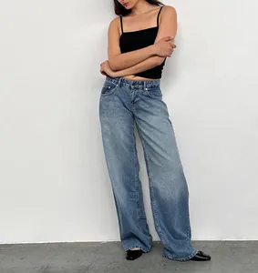 Detail view of women's vintage low-rise wide-leg washed denim jeans in street style