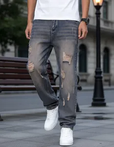 Detailed view of high street distressed straight leg jeans for men in blue wash
