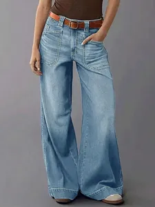 Detailed view of women's wide-leg denim jeans featuring large front patch pockets