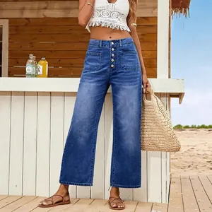 High-waisted blue wide-leg denim jeans with front buttons and patch pockets for summer