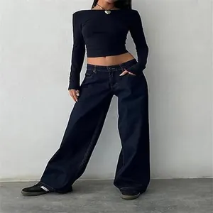 Model wearing retro low-waist wide-leg denim jeans in a vintage street style outfit.