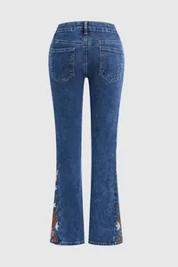 Back view of premium blue denim flare jeans for women featuring elegant floral embroidery