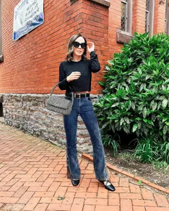 Women's slim fit flare jeans with floral embroidery shown in street style