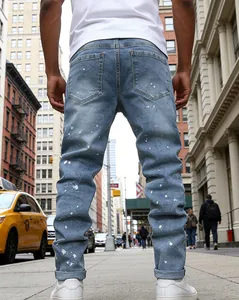Back view of slim fit light blue washed denim jeans with white paint splatter detail