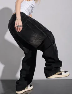 Close-up view of men's black plus-size baggy denim jeans with loose wide-leg straight fit