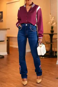 Slim fit flare jeans for women featuring colorful floral embroidery on dark blue denim.