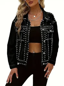 Detailed macro shot of a black women's denim jacket featuring intricate silver rivet patterns