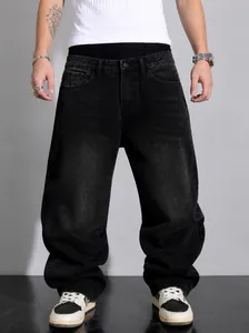 Macro view of men's loose wide-leg black washed denim jeans in urban street style