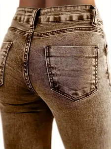 Detailed view of vintage washed high-waisted denim jeans showing back pocket and texture