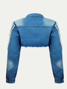 Back view of a cropped light wash denim jacket featuring pearl fringe details on sleeves