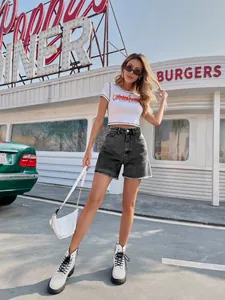 Stylish high-waisted loose denim shorts for women in a retro outdoor street setting