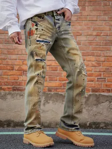 Close-up of vintage distressed men's jeans with paint splatters and ripped details