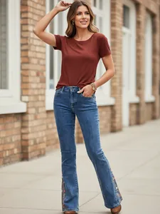 Stylish women's blue flared denim jeans featuring intricate floral embroidery at the hem
