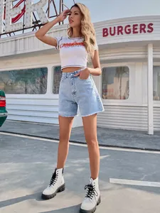 Detail of high-waist loose denim shorts with frayed hems on a fashion model.