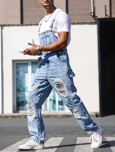 Macro detail of men's ripped denim overalls featuring high-street distressed style
