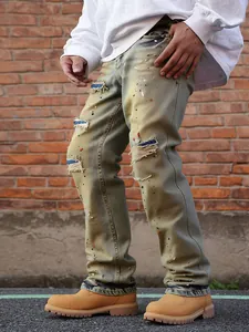Detailed side view of distressed men's straight leg jeans with paint splatter