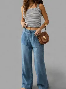 Full-length view of women's loose wide-leg tencel denim trousers with drawstring waist.