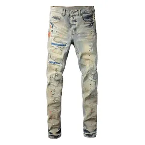 Macro view of light blue distressed straight jeans with paint splatters and ripped detail