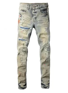Detailed front view of vintage distressed men's jeans with paint splatter and rips
