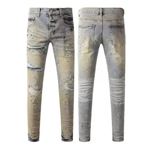 Front and back views of men's vintage distressed slim jeans with paint splatter details
