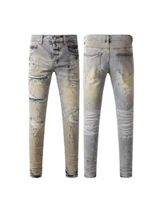 Retro distressed slim fit men's denim jeans with ripped details and paint splatter