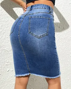 Back view of high-waist denim skirt featuring raw frayed hem and functional pockets