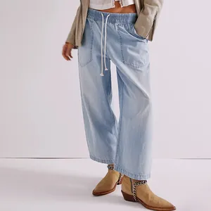 Detailed view of women's light blue washed straight-leg denim pants with drawstring waist