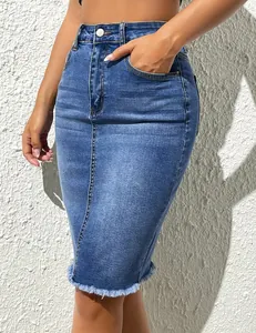 Detailed shot of high waisted denim pencil skirt with stylish frayed hem and pockets
