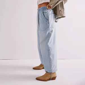 Detail showing the side view of light wash denim cropped pants with drawstring waist.