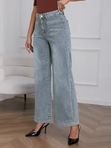 Detail view of high-waisted wide-leg jeans in light wash denim with stylish patch pockets